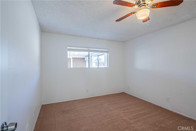 carpeted empty room with ceiling fan and a textured ceiling