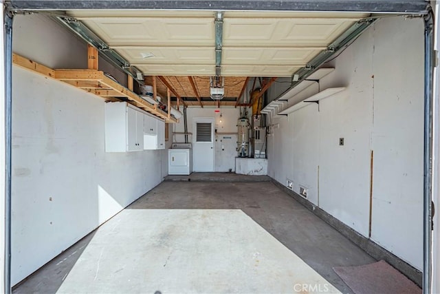 garage with a garage door opener and washer / dryer