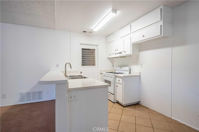 kitchen featuring sink, light tile patterned floors, a textured ceiling, white cabinets, and white range with gas cooktop