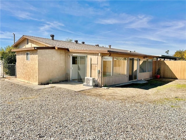 rear view of house featuring a patio area and ac unit