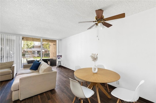 dining area featuring a textured ceiling, ceiling fan, dark hardwood / wood-style floors, and a wall of windows