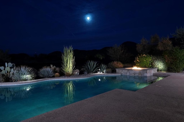 view of pool at twilight