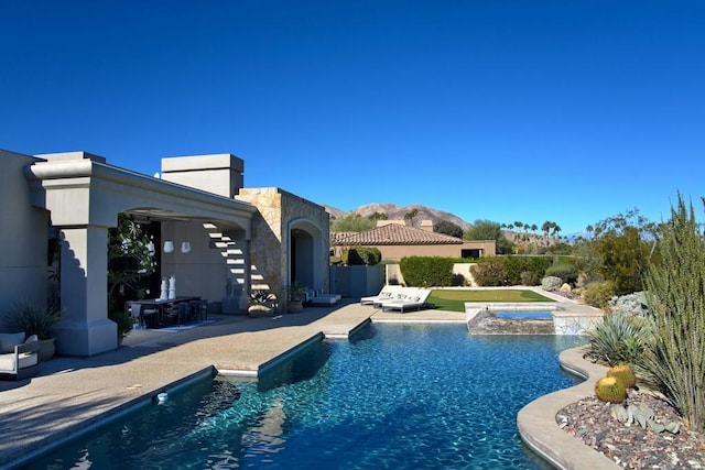 view of swimming pool featuring a patio area and an in ground hot tub