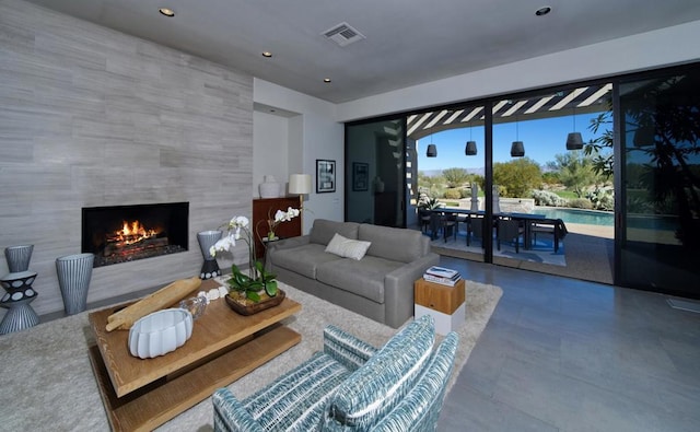 living room with a tile fireplace