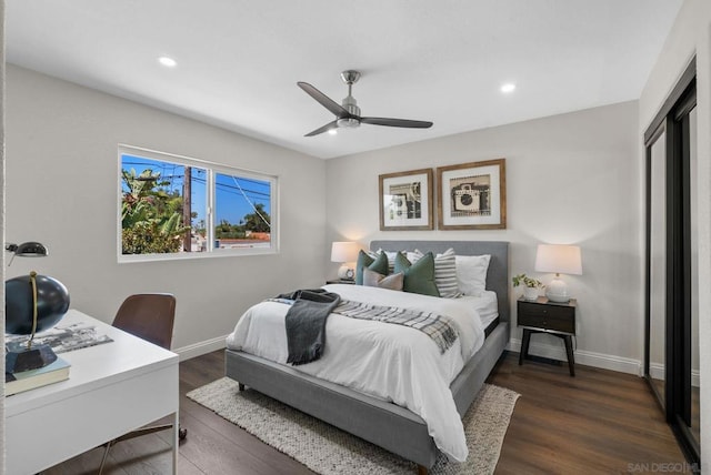 bedroom featuring ceiling fan, dark hardwood / wood-style floors, and a closet