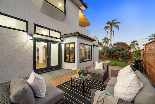 patio terrace at dusk with an outdoor hangout area and french doors