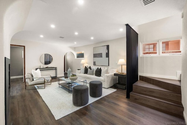 living room with vaulted ceiling and dark wood-type flooring