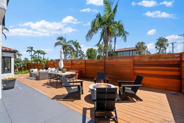 wooden deck with an outdoor living space with a fire pit