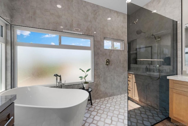 bathroom with vanity, a wealth of natural light, and shower with separate bathtub