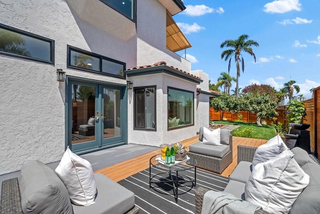 wooden terrace featuring an outdoor living space and french doors