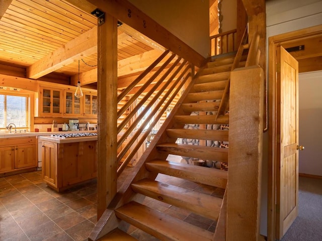 stairs with sink and wooden ceiling