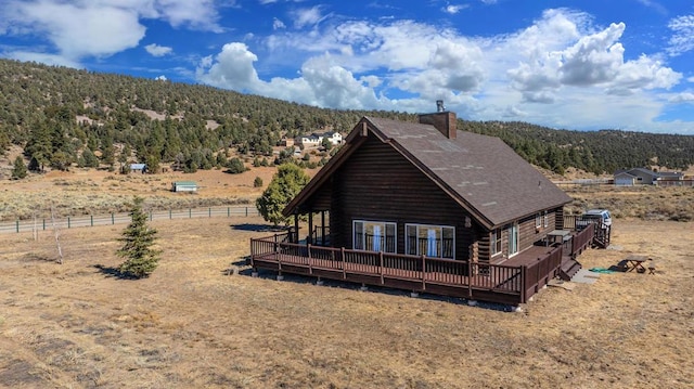 back of house featuring a wooden deck