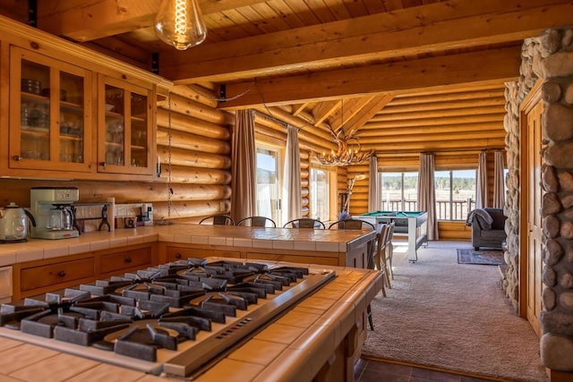 kitchen featuring wood ceiling, log walls, tile countertops, billiards, and stainless steel gas stovetop