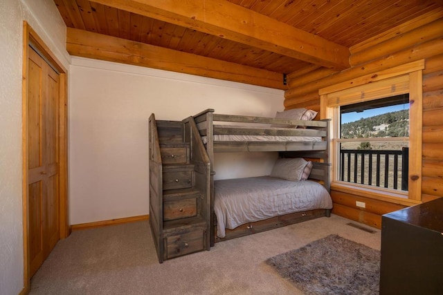 carpeted bedroom featuring beamed ceiling, rustic walls, and wooden ceiling