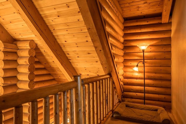 stairs featuring rustic walls and wooden ceiling