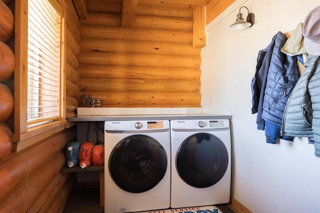 laundry area featuring log walls and washing machine and clothes dryer