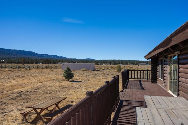 wooden deck with a mountain view and a rural view