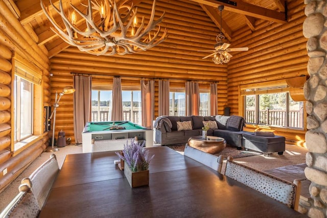 interior space with high vaulted ceiling and log walls