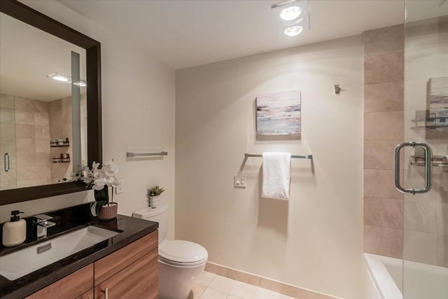 bathroom with toilet, vanity, and tile patterned floors