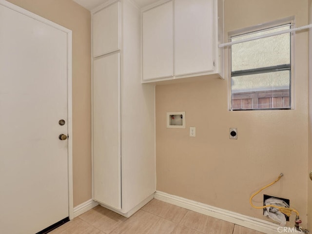 clothes washing area featuring cabinets, washer hookup, and hookup for an electric dryer