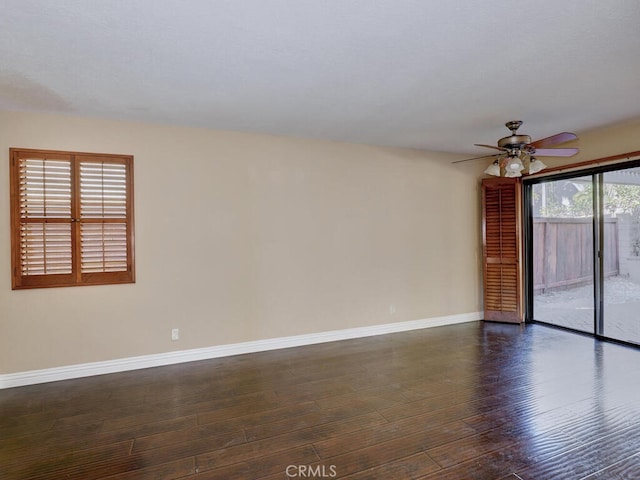 spare room with ceiling fan and dark hardwood / wood-style floors