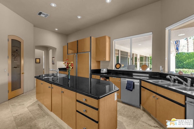 kitchen with dishwasher, paneled built in fridge, sink, and a kitchen island with sink