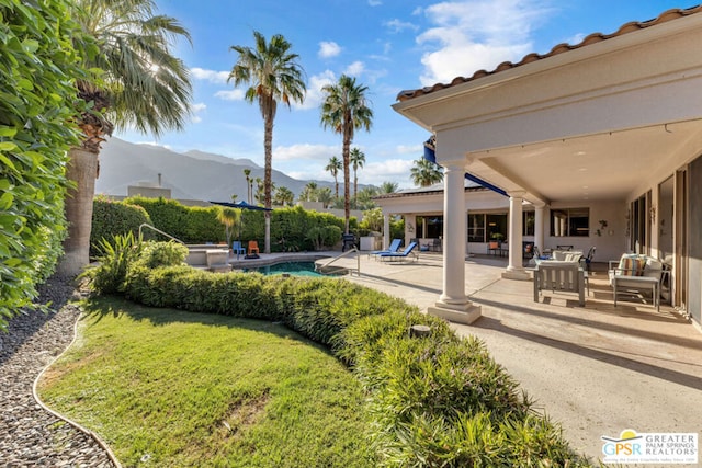 view of yard with a mountain view, a fenced in pool, and a patio