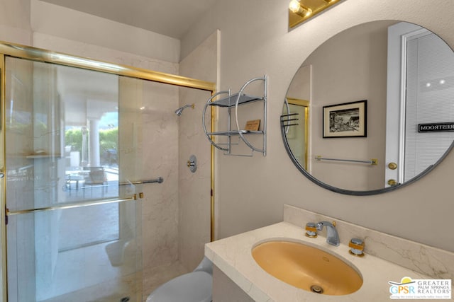 bathroom with vanity, an enclosed shower, and toilet