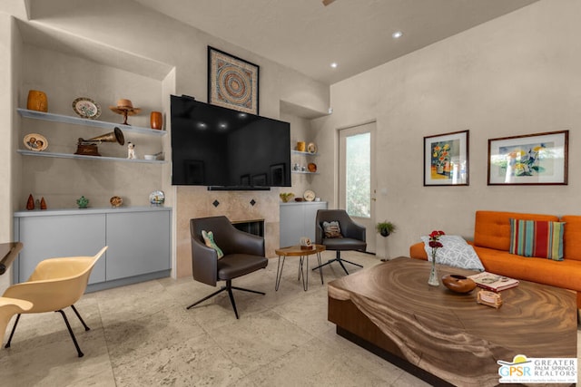 living room with a tile fireplace