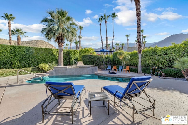 view of pool featuring a mountain view and a patio