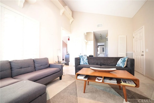 tiled living room with high vaulted ceiling