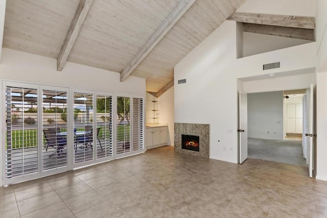 unfurnished living room with beamed ceiling, high vaulted ceiling, wooden ceiling, and a high end fireplace