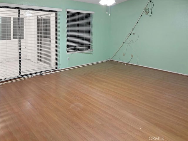 unfurnished room with ceiling fan and wood-type flooring