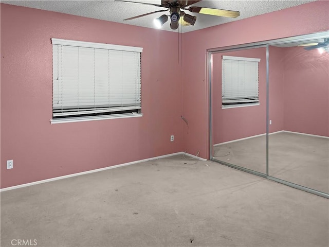 unfurnished bedroom featuring a textured ceiling, ceiling fan, carpet, and a closet