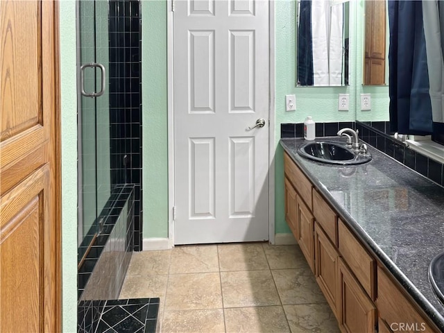 bathroom featuring tile patterned floors, walk in shower, and vanity