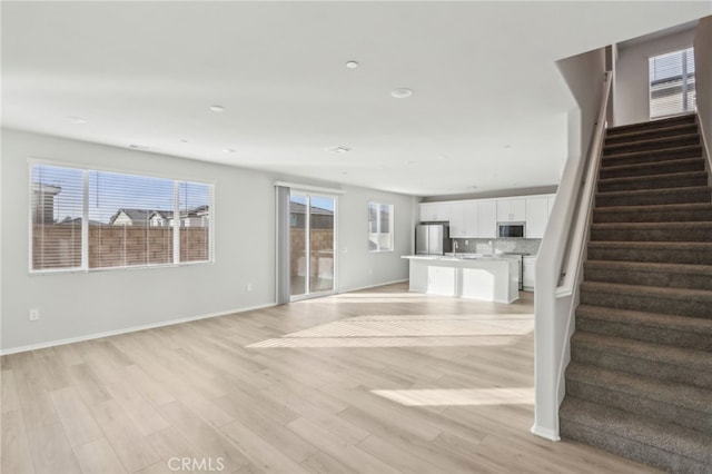 unfurnished living room featuring light hardwood / wood-style flooring