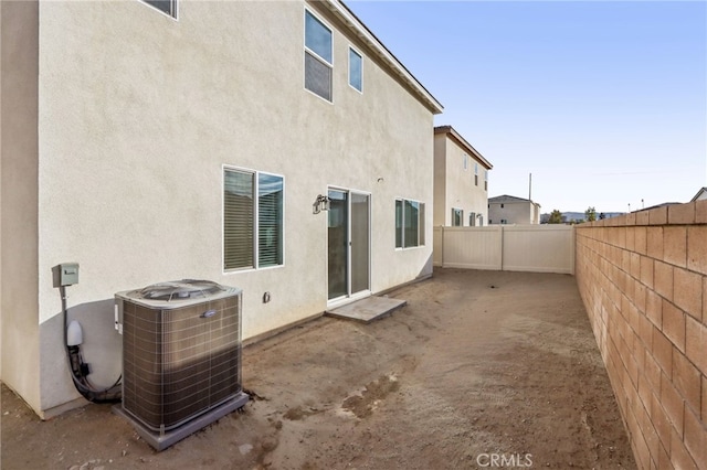 rear view of house with a patio and central air condition unit