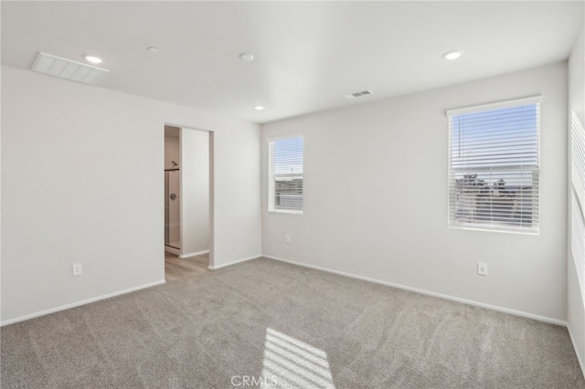 spare room with light colored carpet