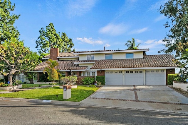 view of front of house with a front lawn and a garage