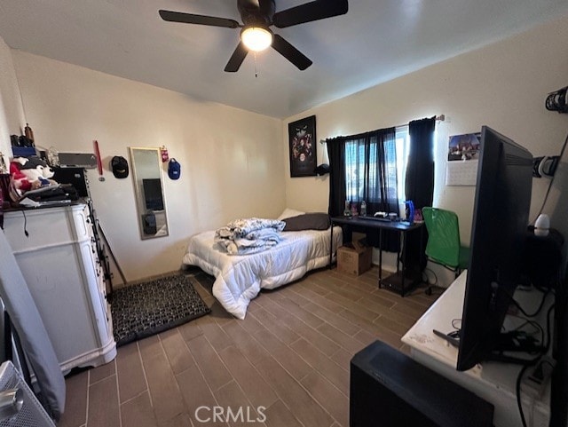 bedroom with dark hardwood / wood-style floors and ceiling fan