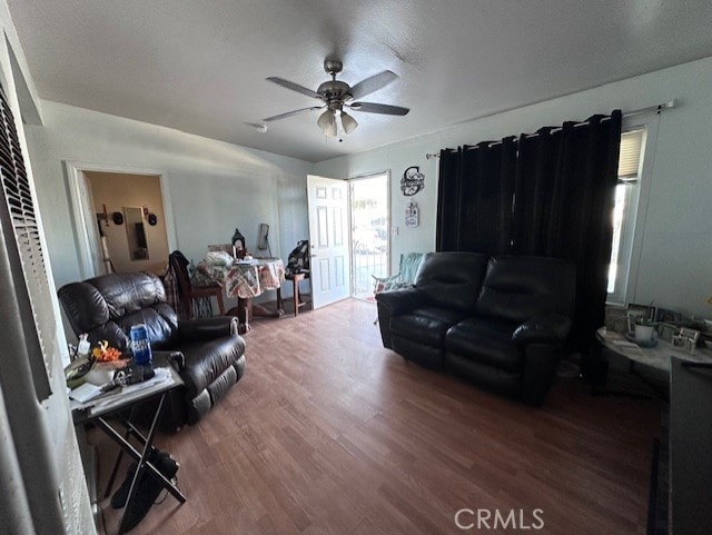 living room with hardwood / wood-style flooring and ceiling fan