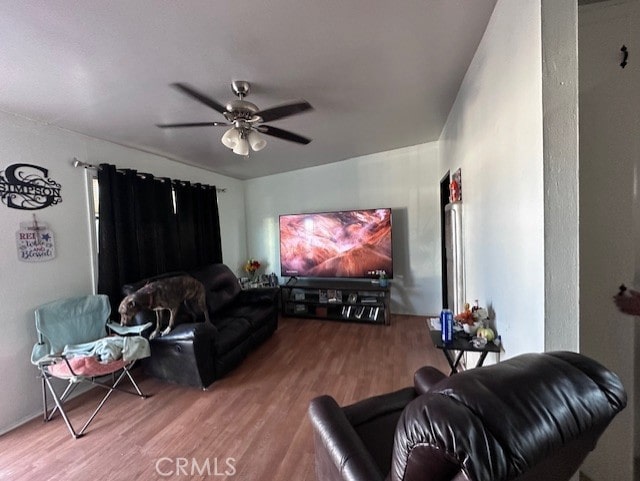 living room featuring hardwood / wood-style flooring and ceiling fan