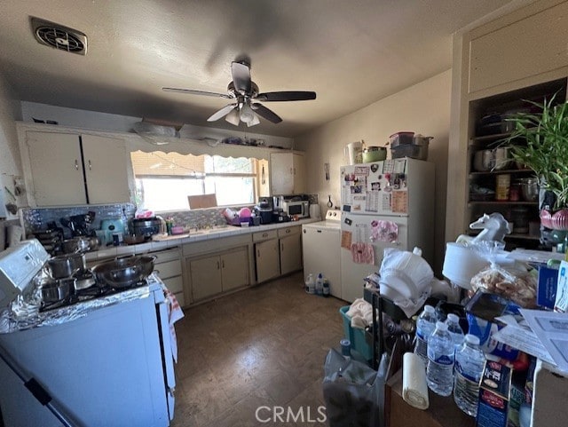 kitchen with ceiling fan, white appliances, washer / clothes dryer, and tasteful backsplash