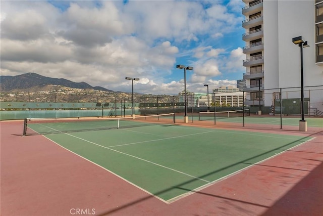 view of tennis court with a mountain view and basketball court