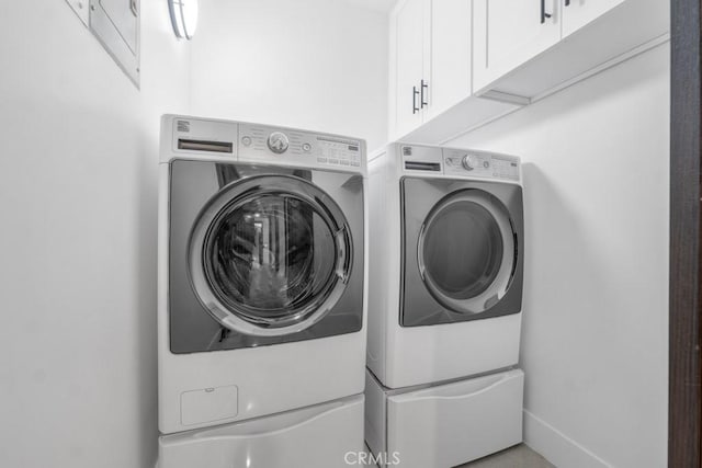 laundry area with cabinets and separate washer and dryer