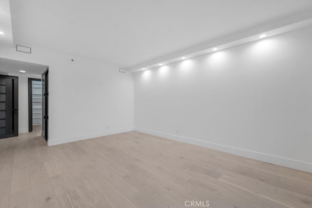 spare room with light wood-type flooring