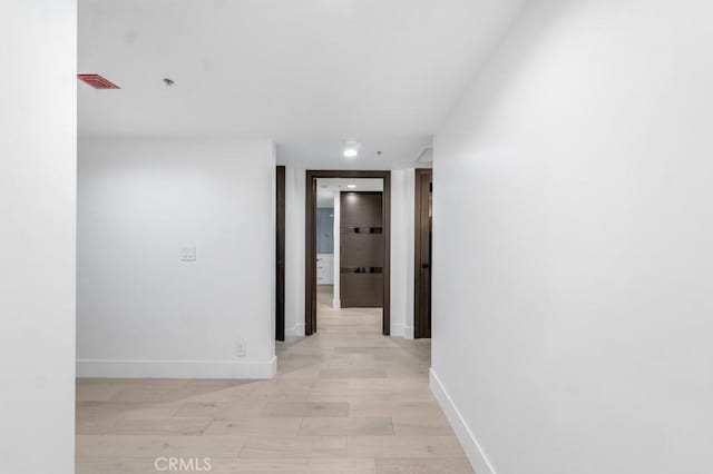 hallway with light hardwood / wood-style flooring