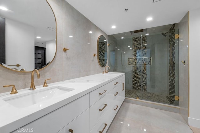 bathroom featuring vanity and an enclosed shower