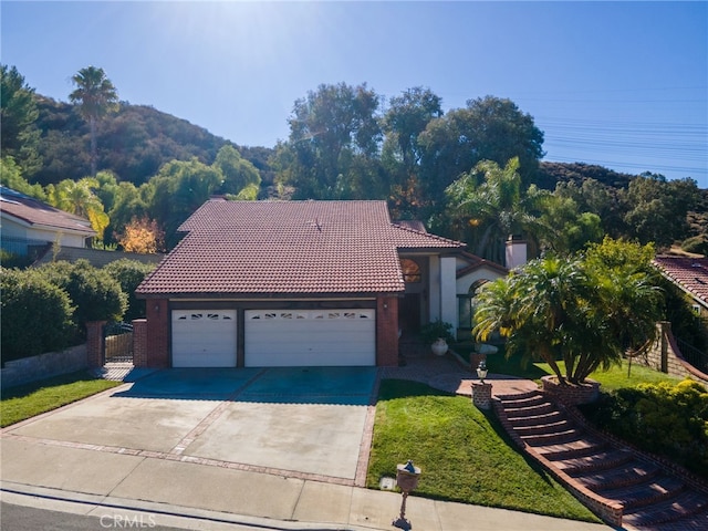 view of front facade with a front lawn and a garage