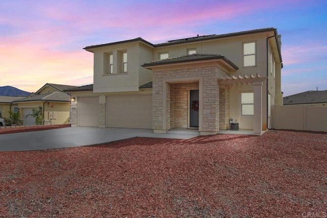 view of front of house featuring central AC and a garage